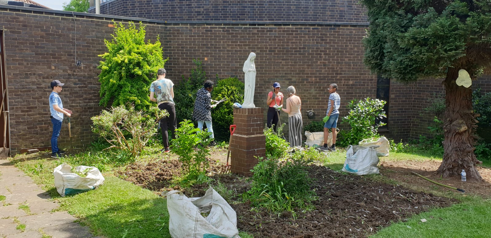 B-Attitudes working on Parish garden.