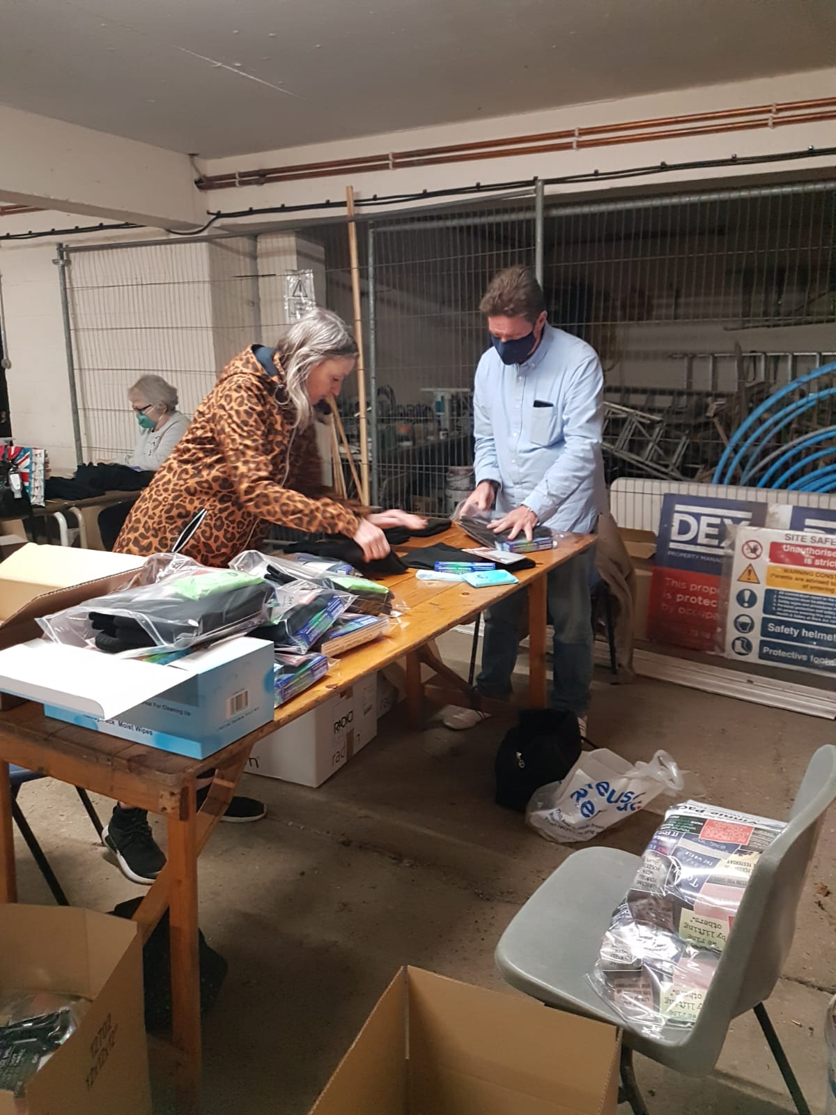 Adult volunteers helping prepare the packs.