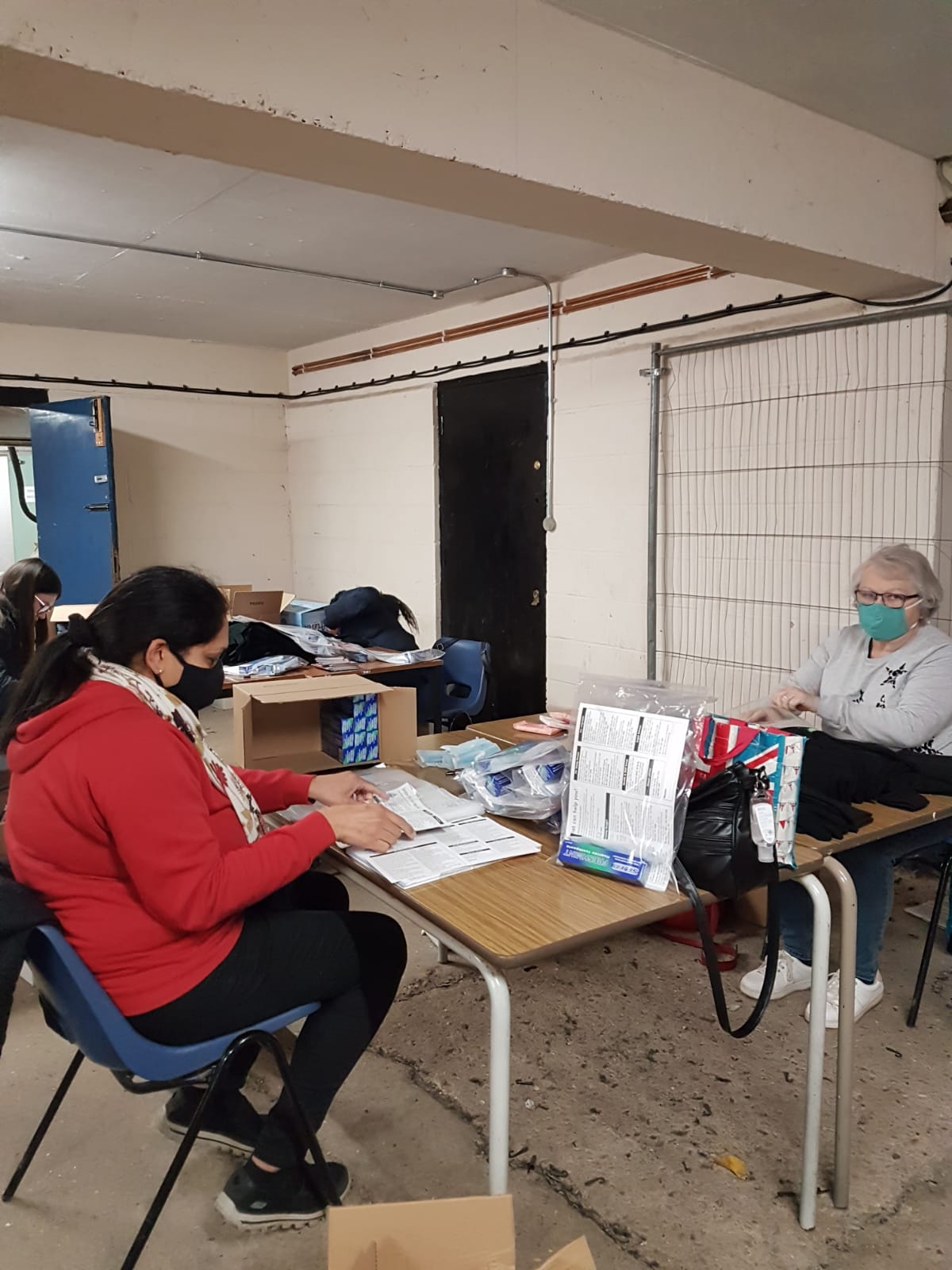 Adult volunteers helping prepare the packs.